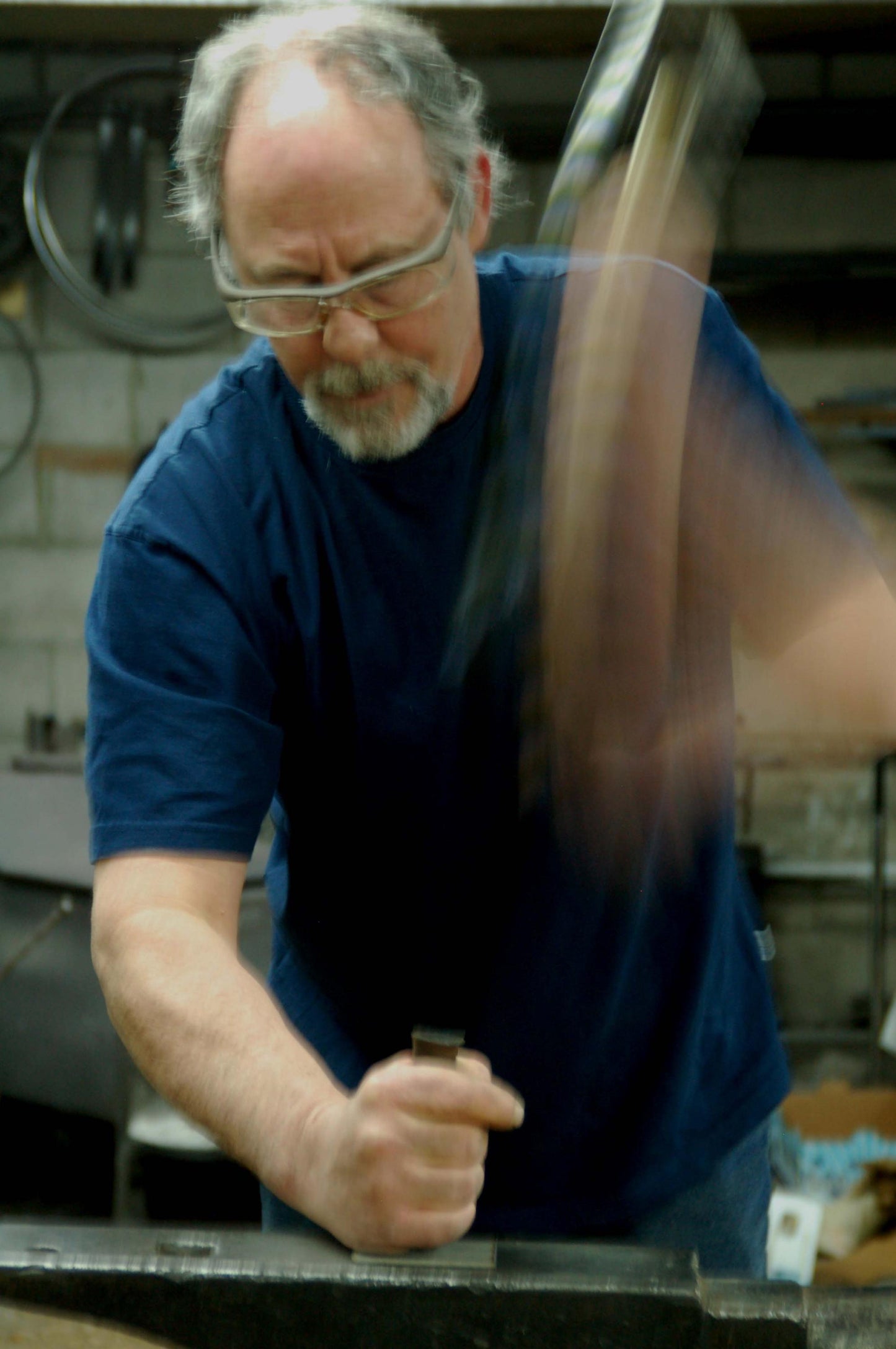 Robert Aucoin, iron artist hammers his signature onto back of each of his one of a kind Canadian made buckles.